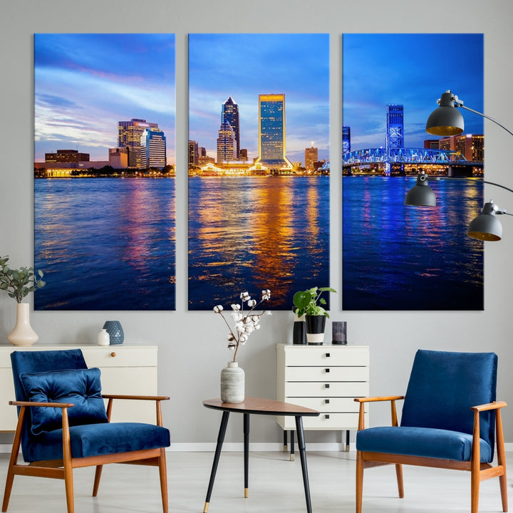 A cozy living room features the Jacksonville Wall Art Canvas Print, a large triptych crafted on museum-quality canvas that beautifully depicts the Jacksonville city skyline at sunset.