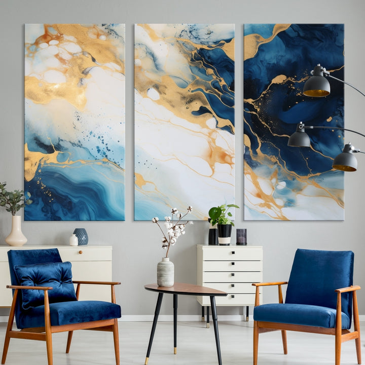 A modern living room featuring museum-quality Blue Gold Abstract Wall Art Print Contemporary art in a triptych arrangement.