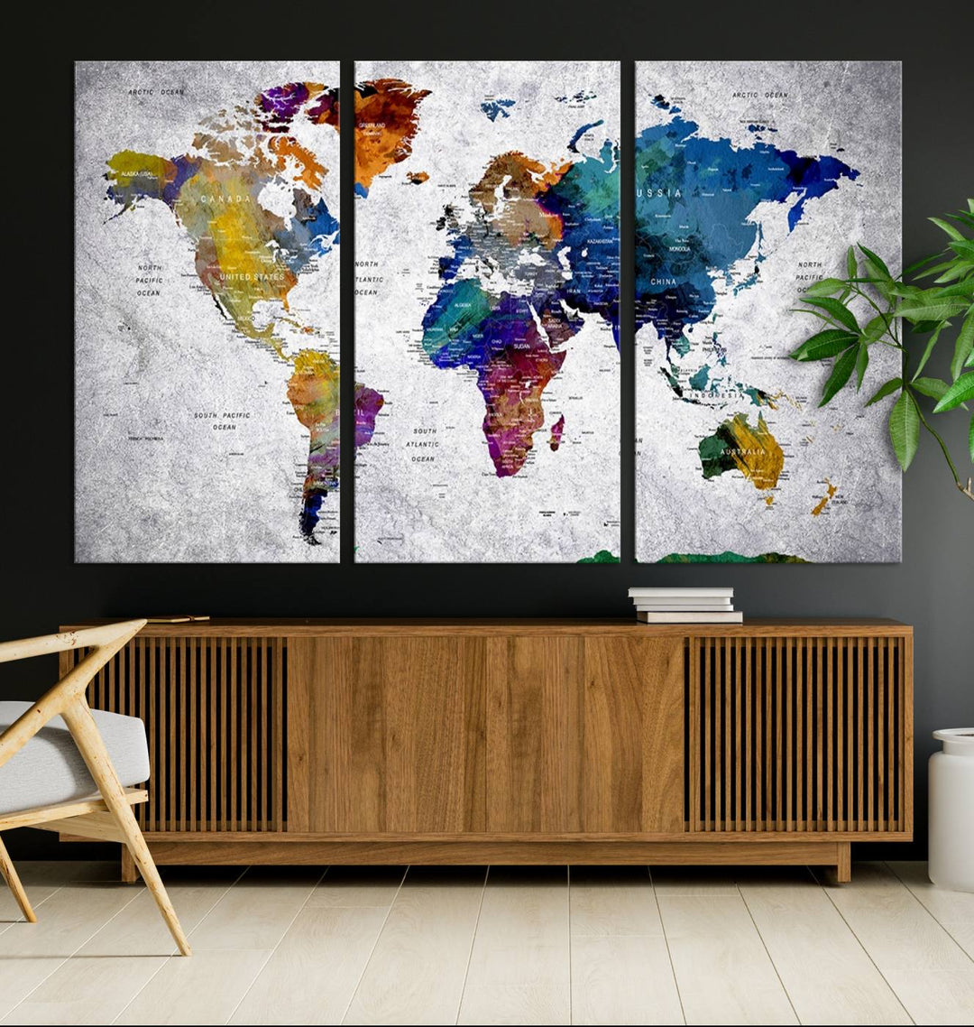 The World Map Art Canvas Print, featuring country names on a grunge-stained gray background, is perfect for stylish home decor.