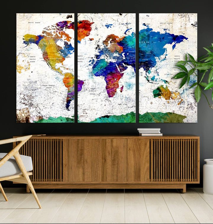 The wall art features the Colorful Abstract World Map – a vibrant contemporary triptych map print.