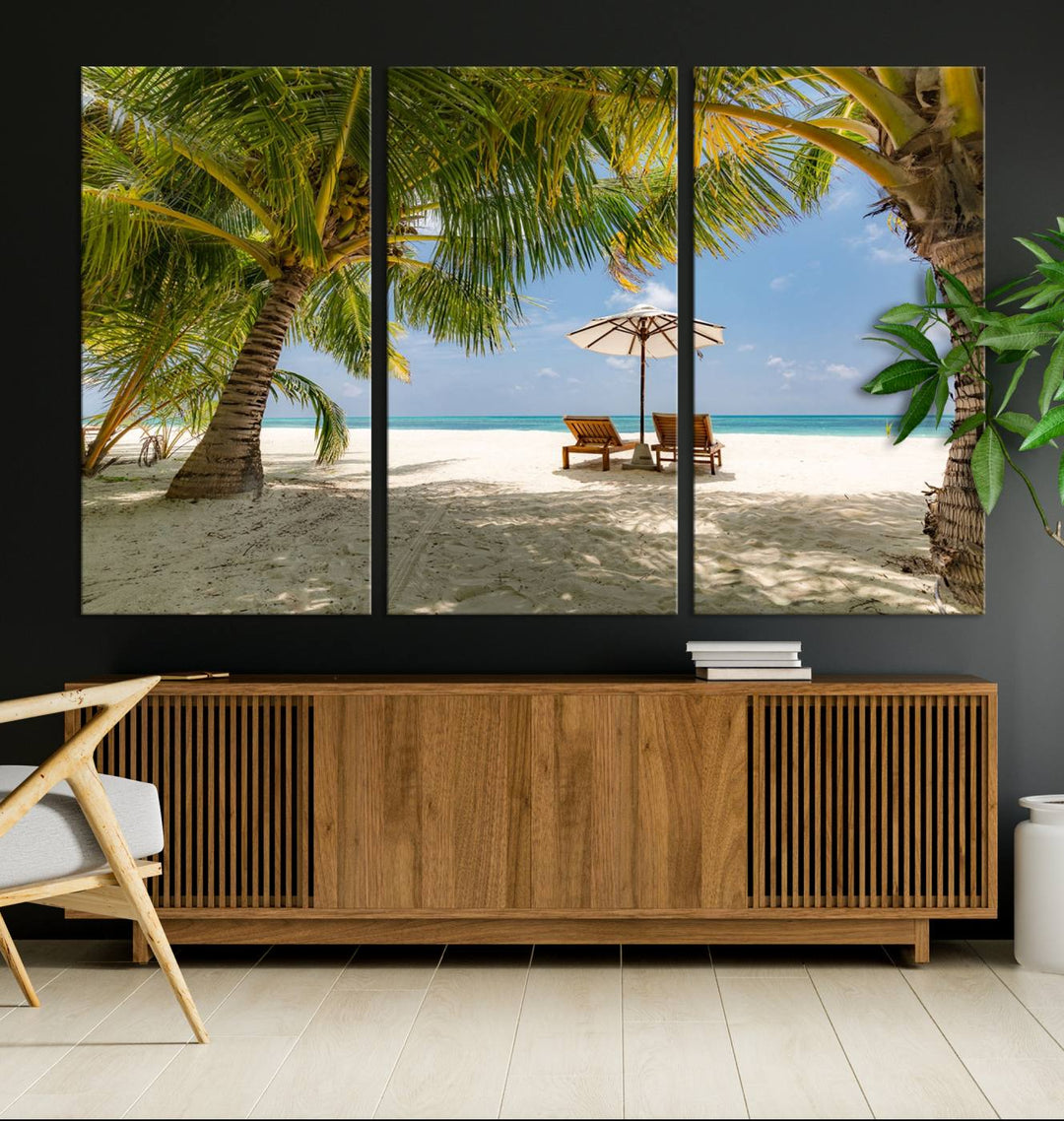 The canvas art print titled Lounge Chairs Palm Trees on Tropical Beach offers free shipping.