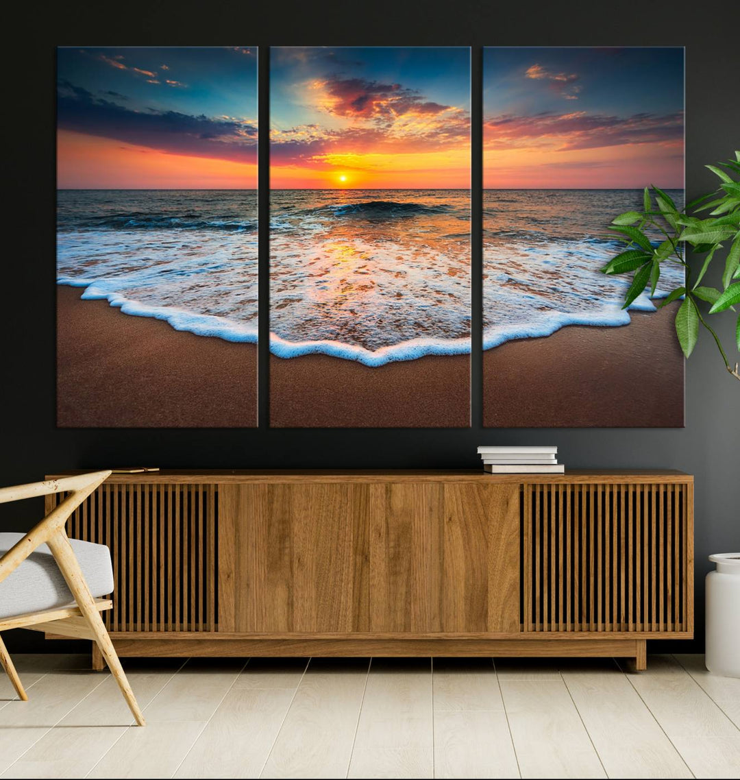 A Sunset with Calm Waves on the Beach Wall Art Canvas Print adorns the dining room.