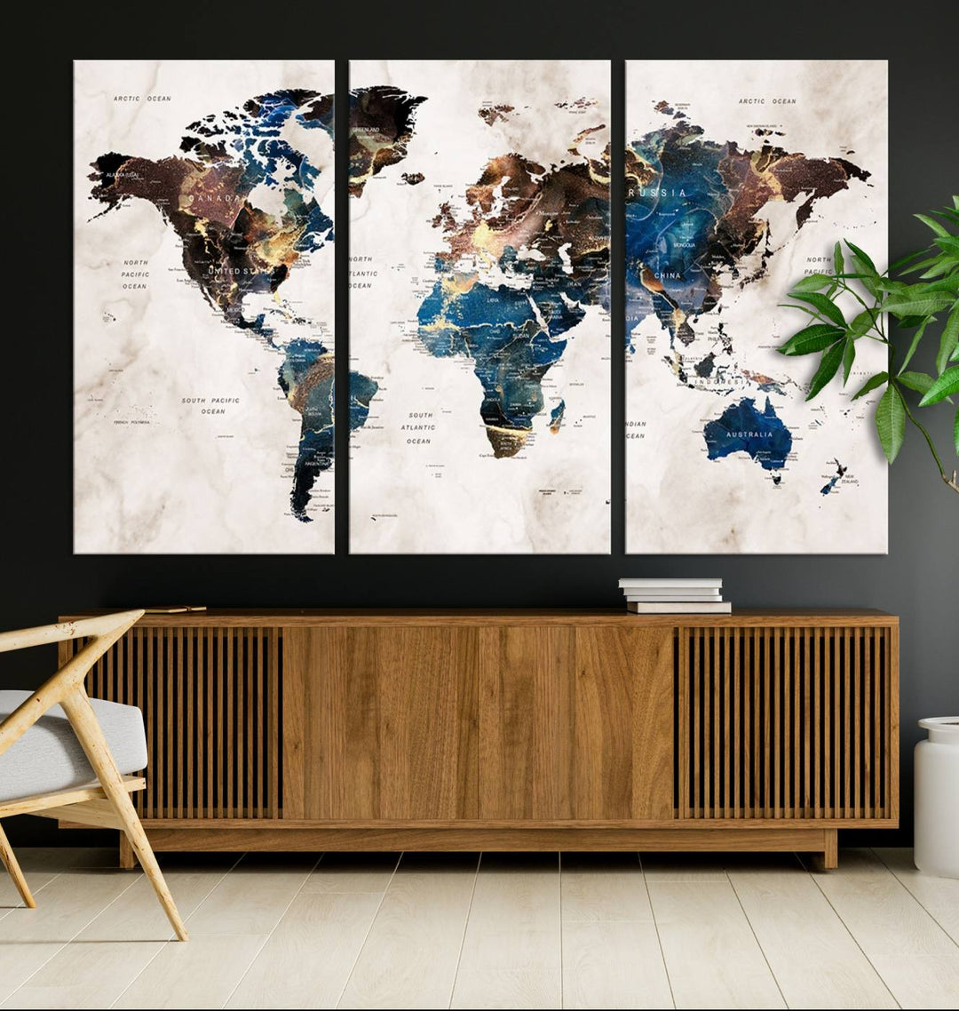 Abstract earth-toned 3-panel world map wall art featuring blues and browns, ready to hang; it showcases continents on modern canvas.