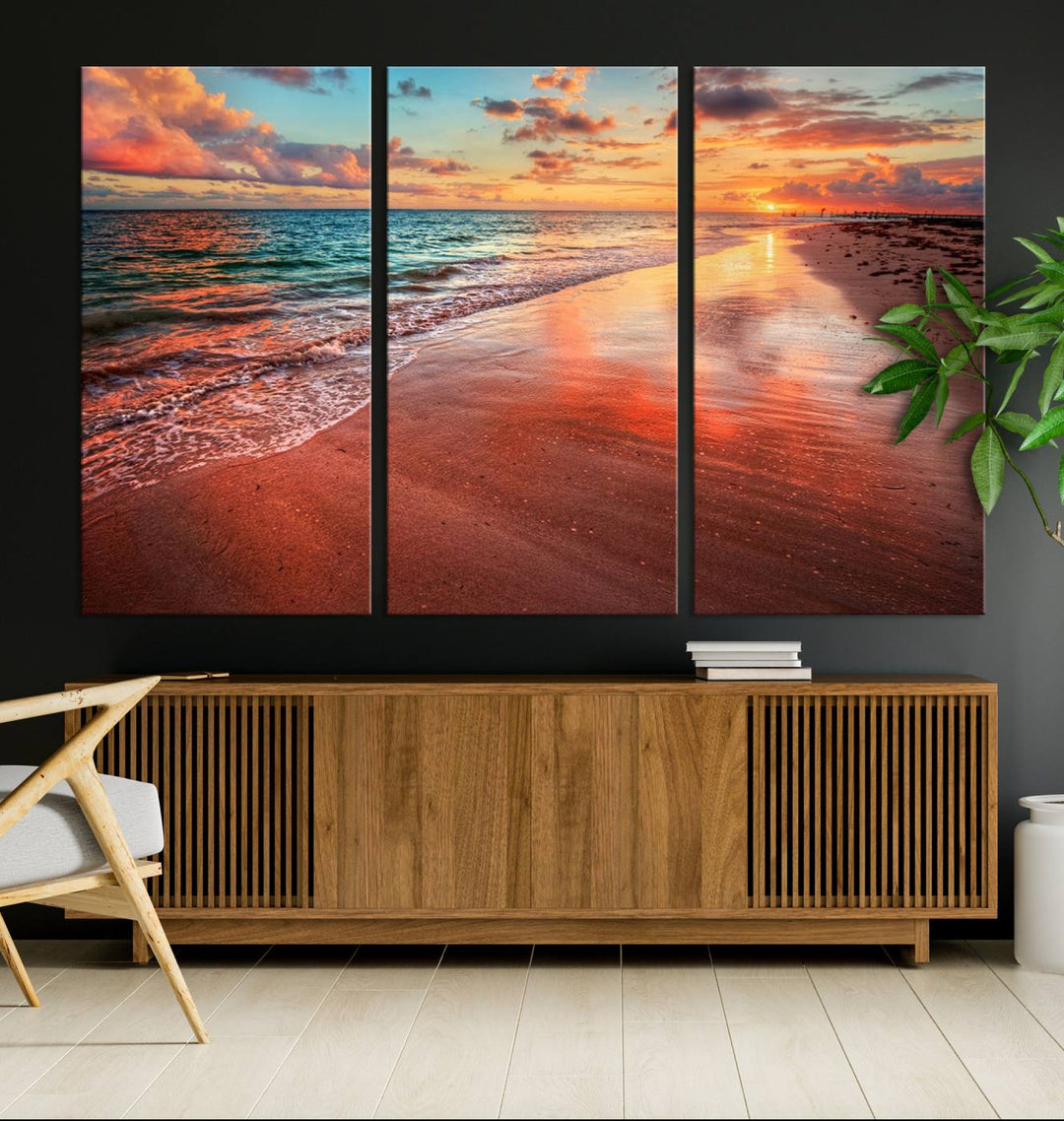 A Vibrant Sunset Beach Canvas Print with ocean waves and sandy shoreline enhances coastal-themed interiors.