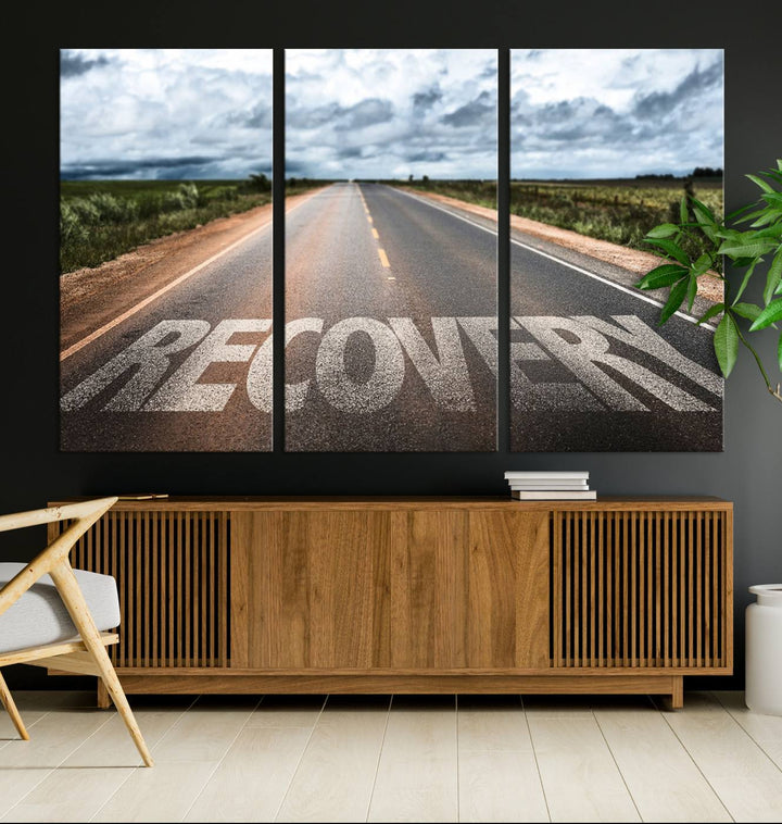 The Recovery Road Wall Art Canvas Print depicts a road under a cloudy horizon.