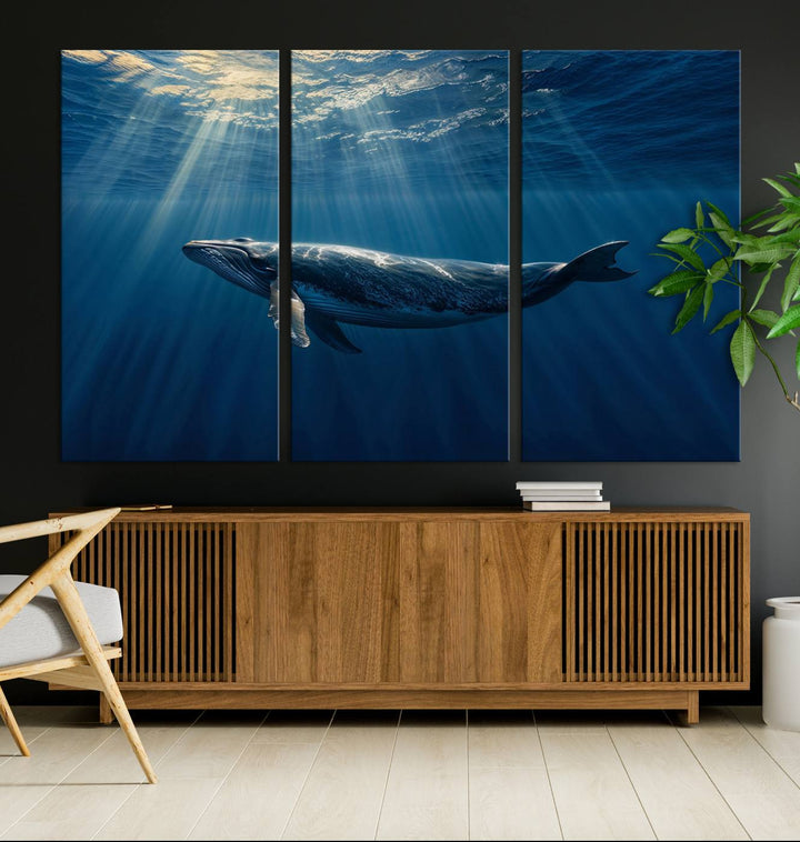 The Whale under Ocean wall art canvas print graces the white wall.