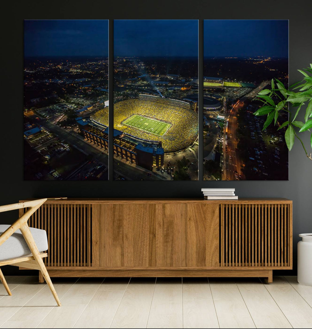 Aerial view of Michigan Stadium at night, surrounded by city lights, depicted on a Michigan Wolverines wall art canvas print.