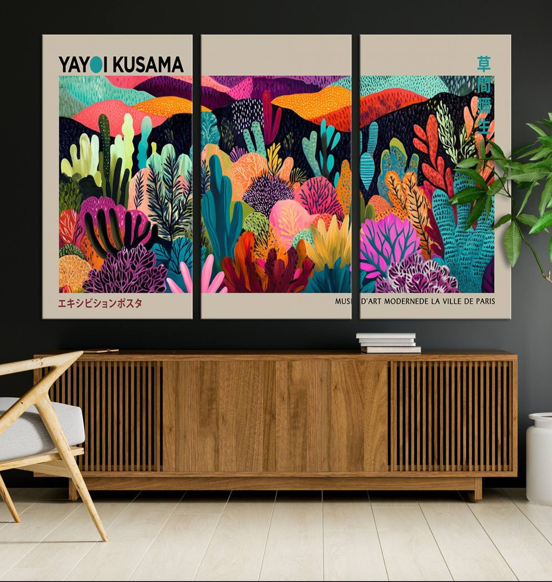 The framed Yayoi Kusama wall art adds vibrancy above the blue couch.