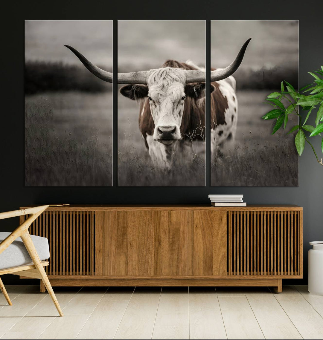 The Texas Longhorn Cow Canvas Wall Art Print adds a rustic touch to a living room.