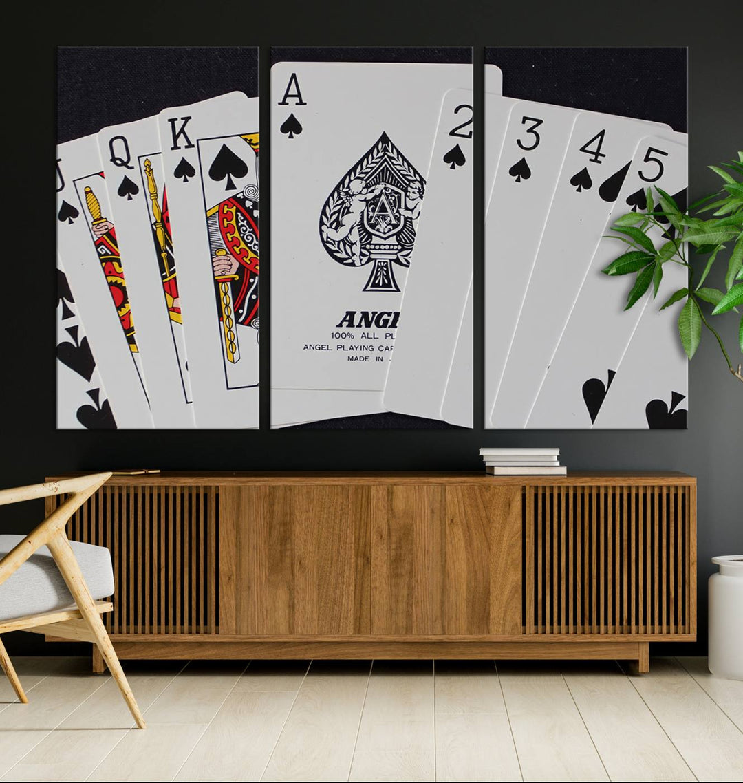 The Poker Wall Art - Playing Cards Canvas Wall Art Print features an Ace of Spades and Royal Flush design. This piece adds a classic charm to any space with its subtle emphasis on the Ace of Spades, making it perfect for game room decor.