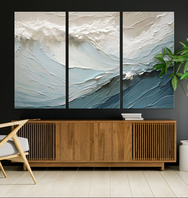 The Waves Abstract Wall Art Print, a captivating piece of modern framed abstract canvas, beautifully decorates the wall. This abstract painting is designed to enhance your living room decor and offers the convenience of being ready to hang.