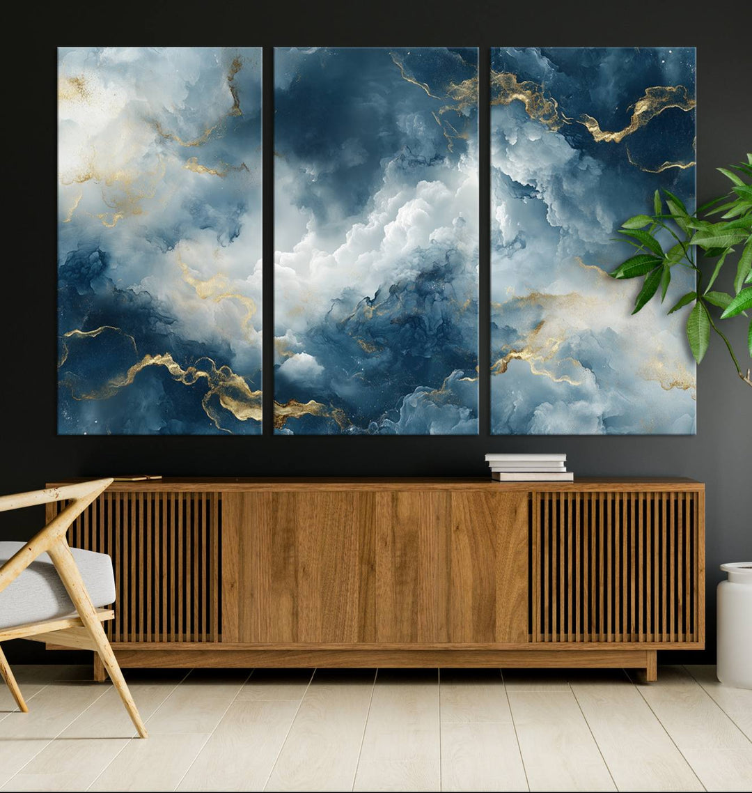 Modern living room featuring the Large Abstract Print - Luxe Blue and Gold Abstract Canvas Wall Art that showcases a bold cloudscape, perfect for modern home decor.