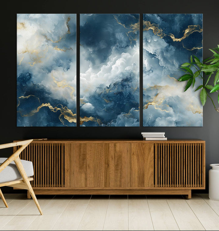 Modern living room featuring the Large Abstract Print - Luxe Blue and Gold Abstract Canvas Wall Art that showcases a bold cloudscape, perfect for modern home decor.