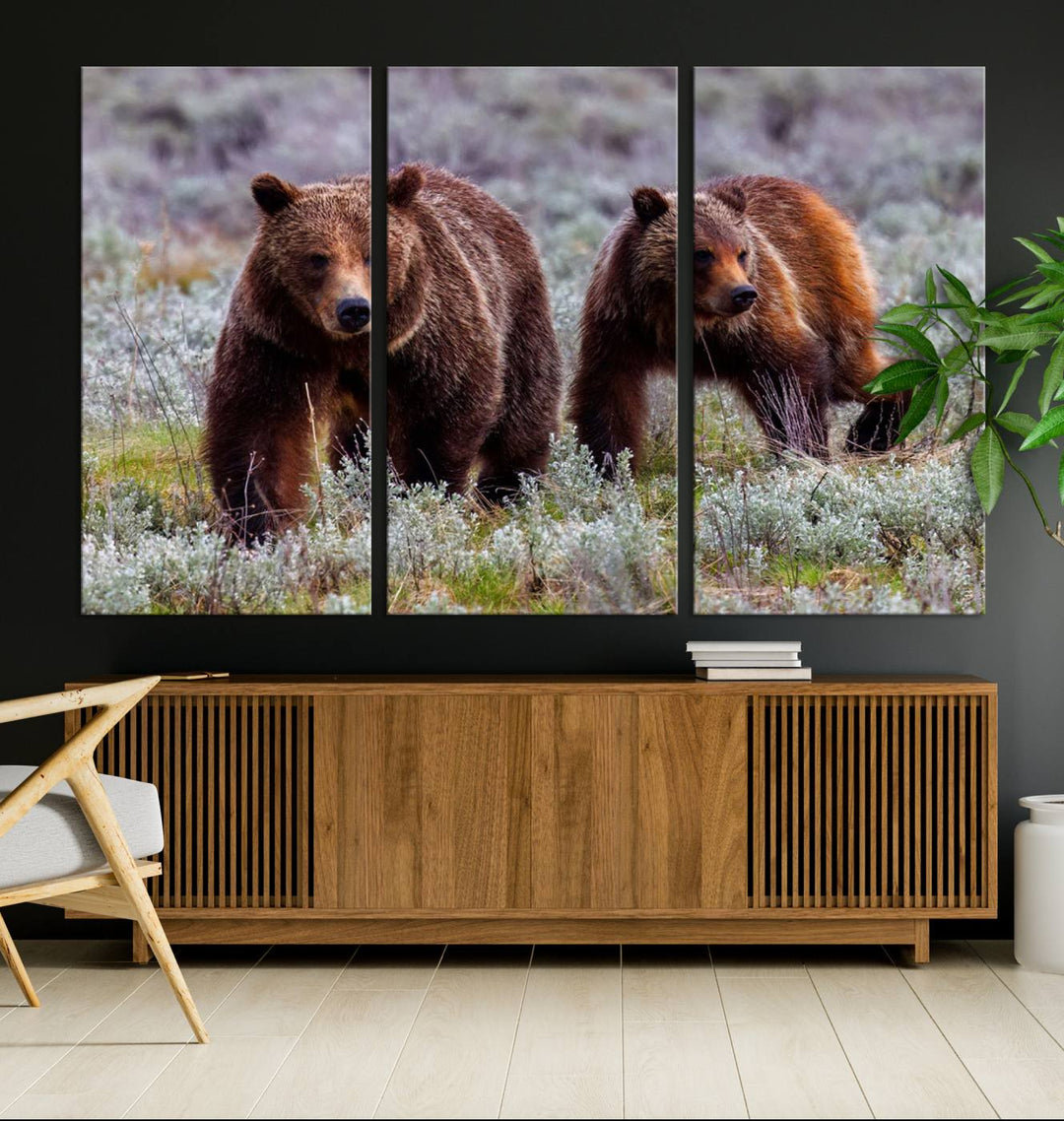 The "Queen of the Tetons" is a stunning canvas art print featuring Grizzly 399 and two bears strolling through a grassy field. Its gallery-quality finish beautifully captures the essence of nature, making it perfect for rustic home decor.