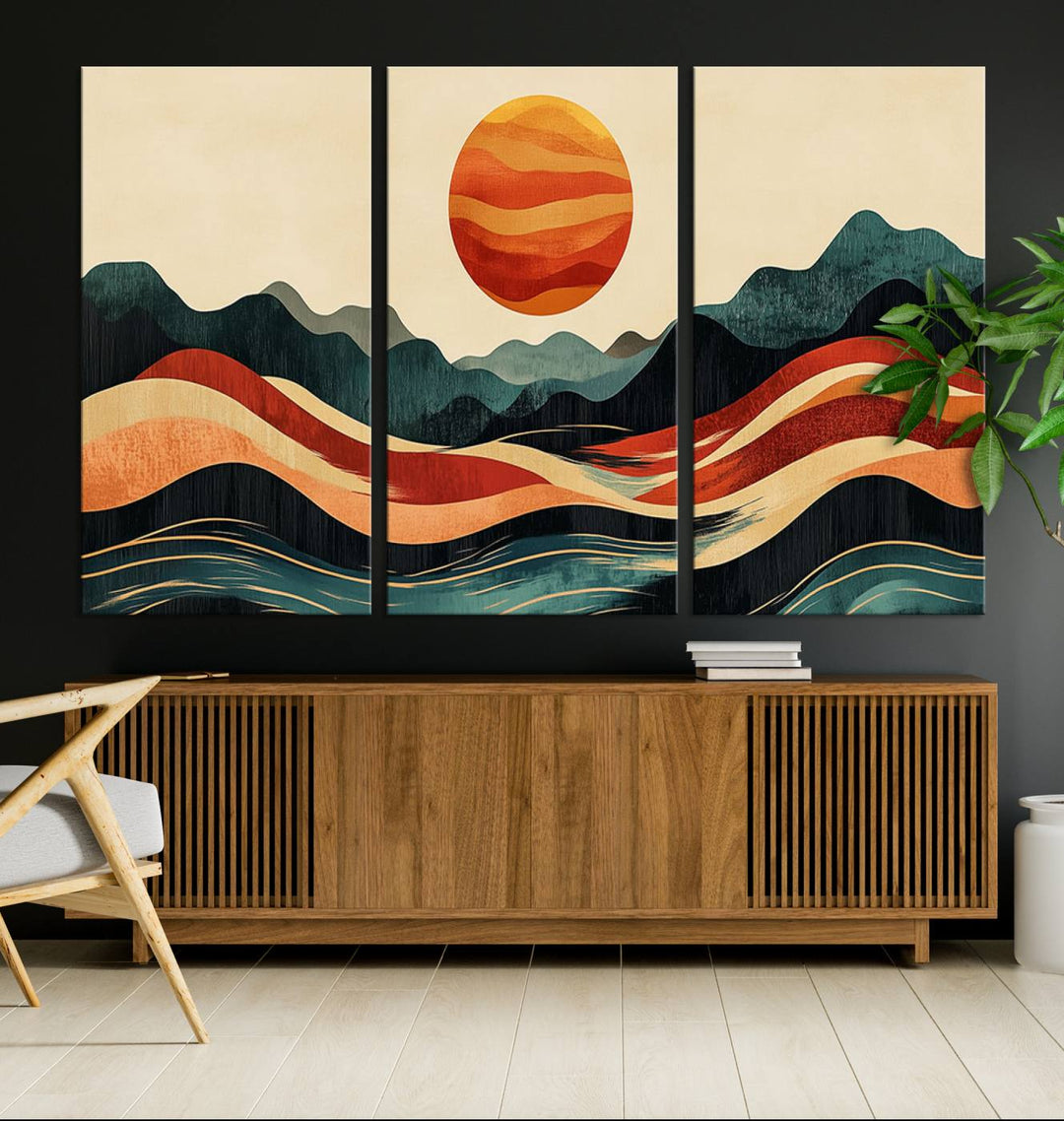 The Mountain Triptych wall art, featuring a design of the sun, mountains, and waves, is displayed prominently on the wall.