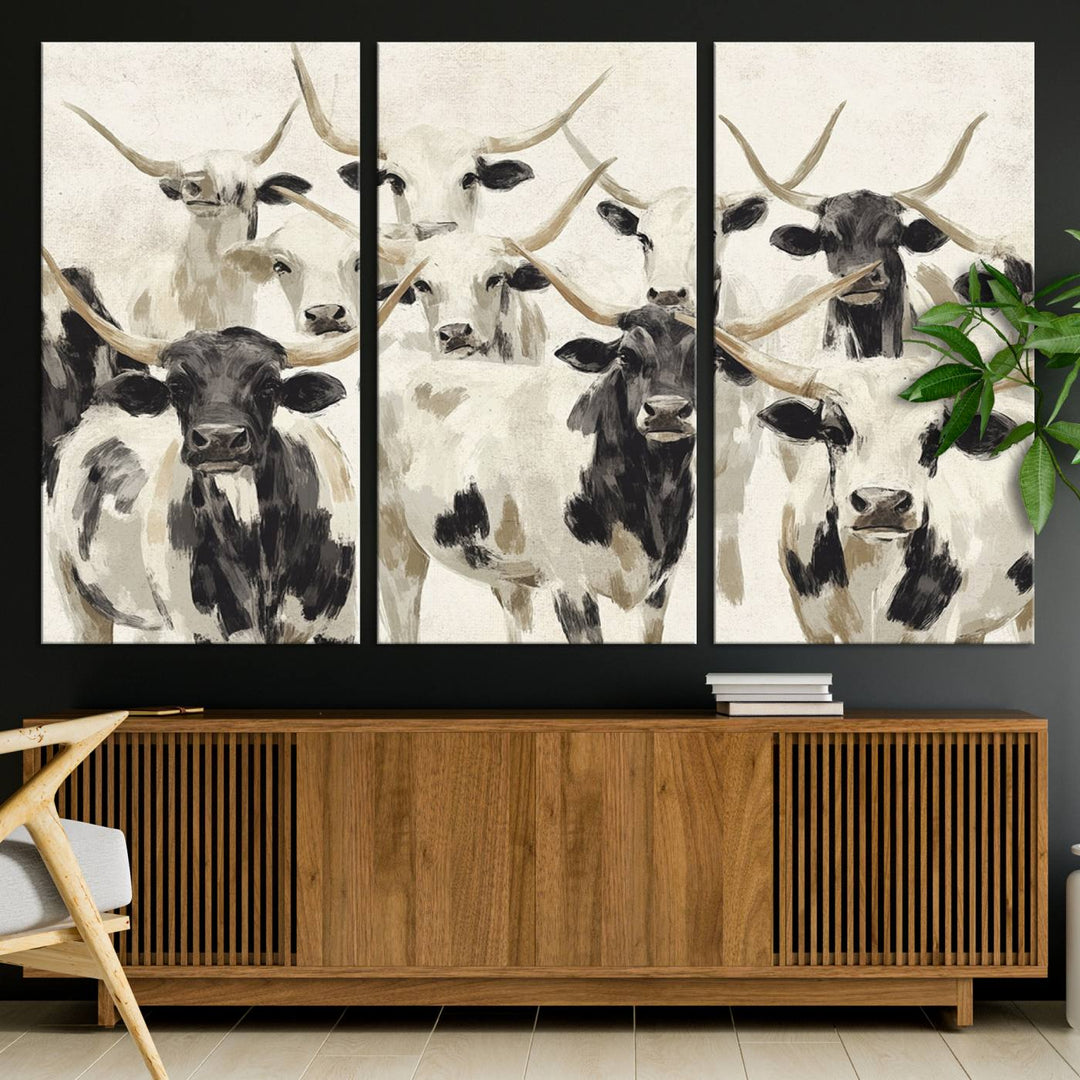 Canvas print titled Longhorn Texas Cow Drawing, depicting longhorn cattle with black and white markings, made in the USA, displayed on the wall.