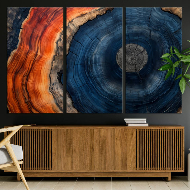 Abstract Tree Ring Wall Art Print on canvas featuring vibrant blue, orange, and brown rings with a natural rustic wood texture. Free shipping available!.