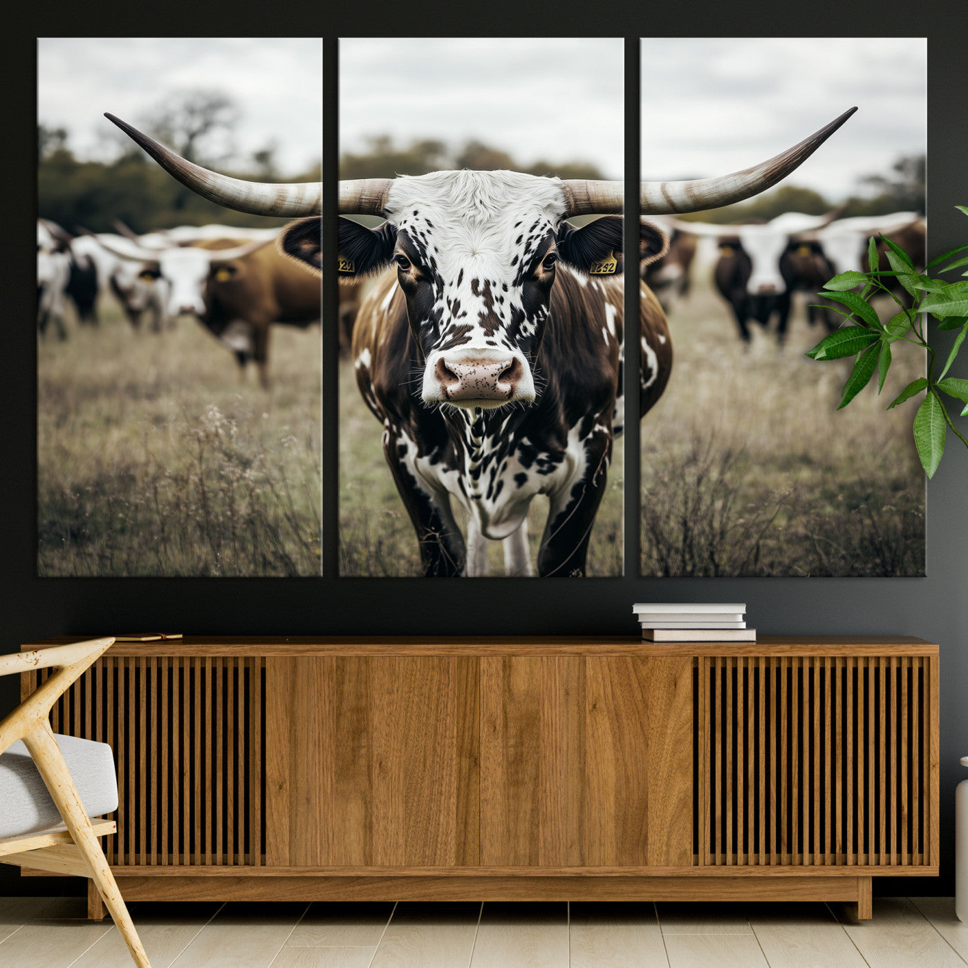 Canvas of a speckled Texas longhorn standing boldly in a field with a herd behind, perfect for rustic western or farmhouse wall decor.