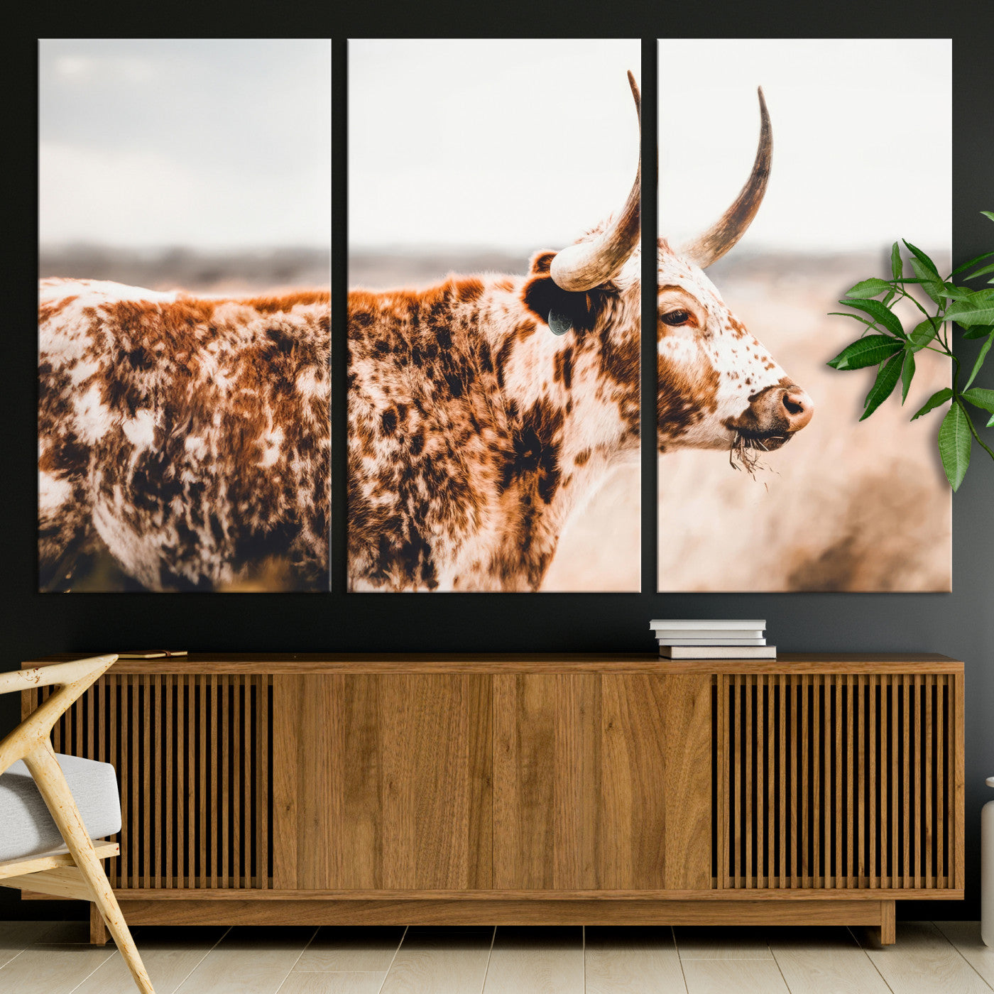 Speckled Texas longhorn with curved horns standing in a warm-toned prairie, perfect for rustic or country-style home decor.