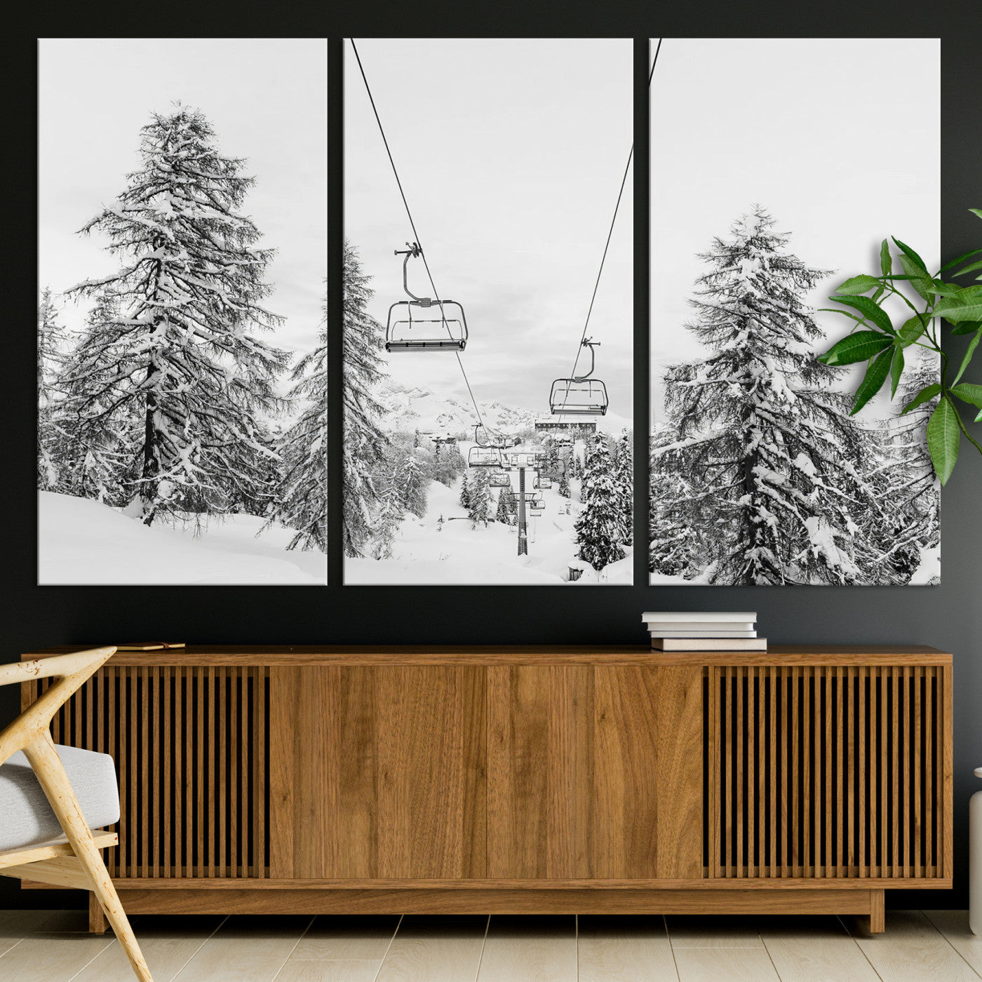 Black and white image of a ski lift amidst snow-covered pine trees, ideal for winter mountain or cabin-themed decor.
