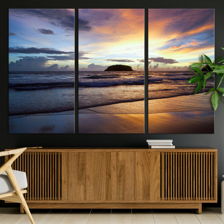 A tropical beach at sunset with waves gently washing ashore, reflecting golden and purple hues in the sky, creating a tranquil coastal scene.