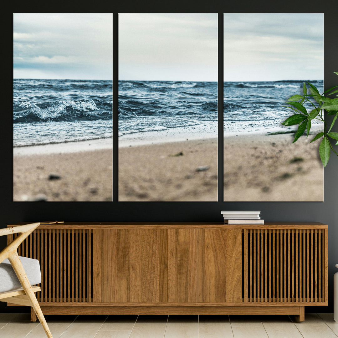A moody ocean scene with gentle waves washing onto a sandy beach under a cloudy sky, creating a peaceful and coastal atmosphere.