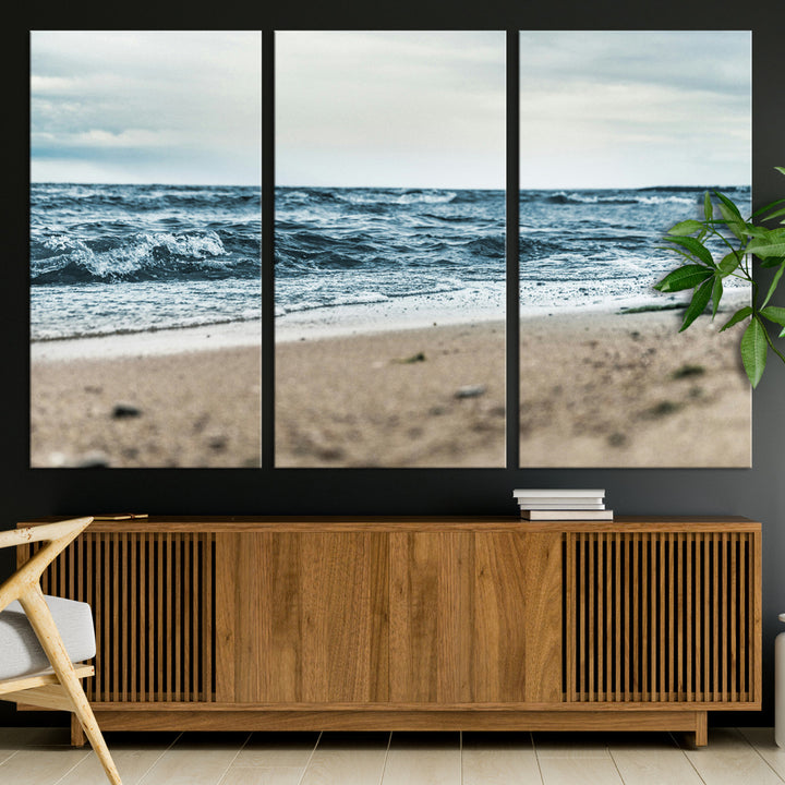 A moody ocean scene with gentle waves washing onto a sandy beach under a cloudy sky, creating a peaceful and coastal atmosphere.