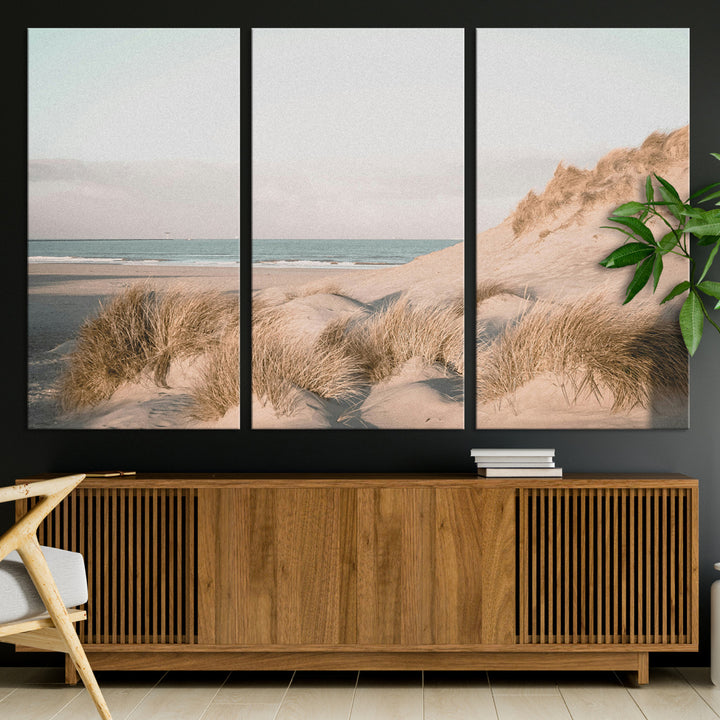 Soft pastel-toned beach scene with sand dunes, windswept grasses, and a calm ocean horizon, creating a serene coastal atmosphere.