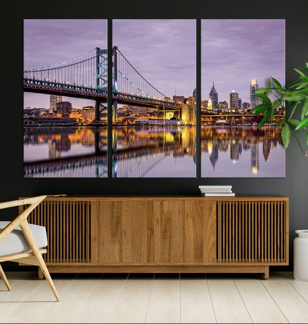 A woman holds the Philadelphia Ben Franklin Bridge Wall Art Canvas Print, a gallery-quality photo showcasing a city skyline with the bridge reflecting on the river. This stunning piece would make an excellent addition as premium canvas wall art for any home.