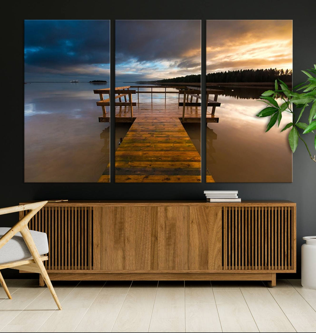 The "Serene Lake Pier at Sunset" landscape canvas print, crafted as ready-to-hang and framed wall art, enriches the contemporary setting by capturing the tranquility of a lakeside pier at sunset.