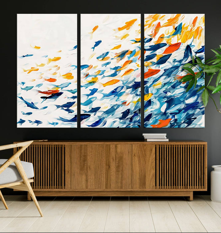 A colorful Abstract Fish Shoal Canvas Print hangs on the wall.