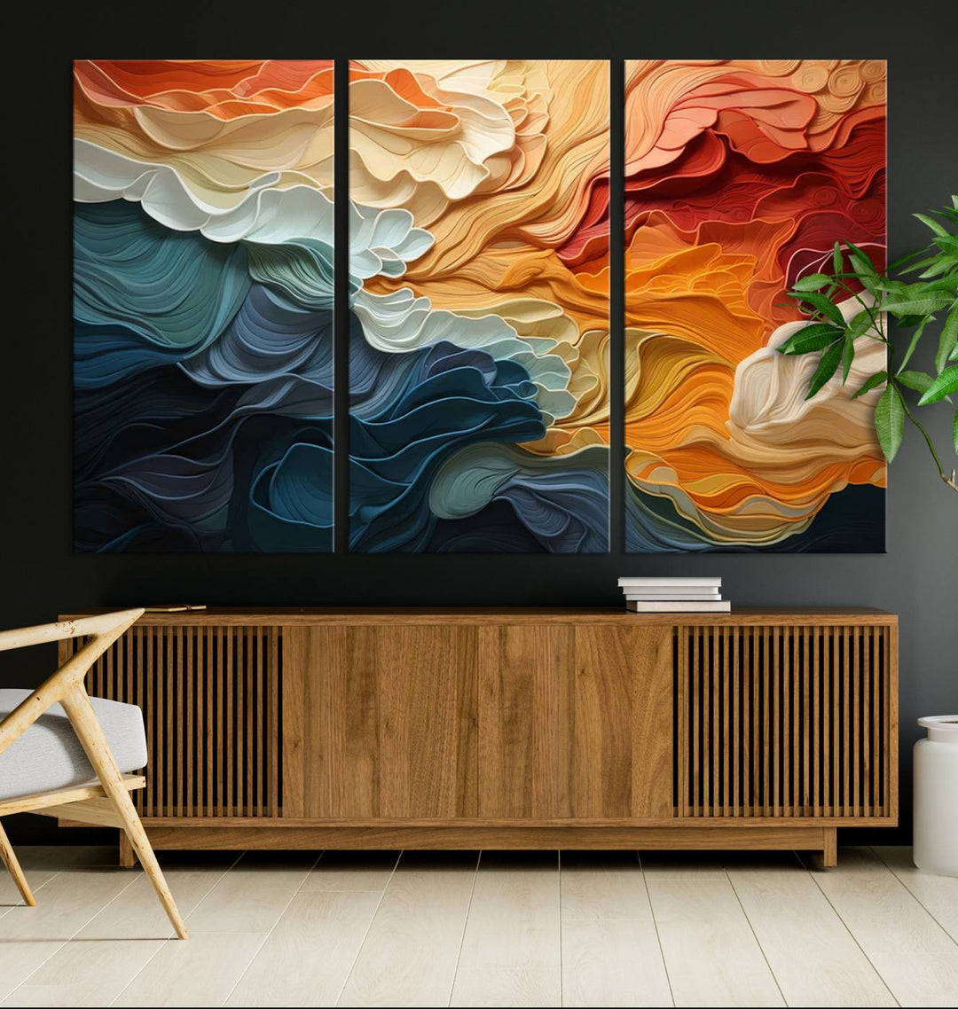 A Blue Orange Abstract Wave Wall Art Canvas Print adorns the wall. This colorful masterpiece is professionally hand-assembled to enhance any space.