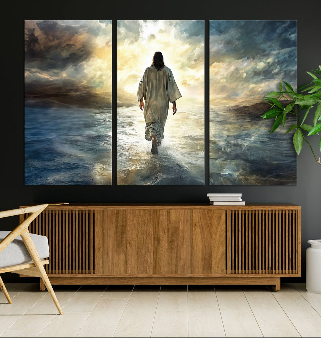 The Jesus Walking on Water Wall Art, a captivating triptych canvas print, showcases a person walking on water beneath dramatic clouds. This ready-to-hang piece seamlessly combines faith and style for your Christian home decor.