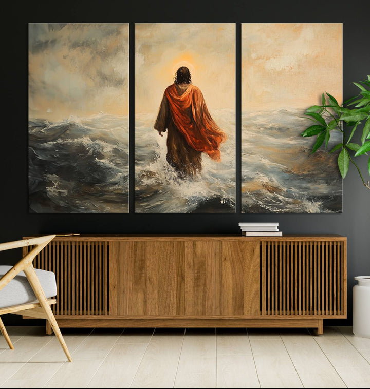 This triptych wall art, titled "Jesus Walking on Water," presents a figure in a red cloak crossing turbulent seas. It is perfect for those looking for religious home decor with a contemporary flair.