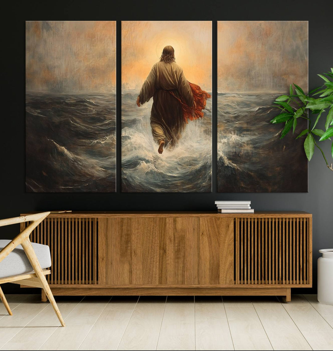 A modern living room is adorned with a triptych titled "Jesus Walking on Water, Christian Wall Art, Jesus Christ Walking on Oil Painting Style Print." The artwork, presented on museum-quality canvas, showcases vibrant colors and exquisite detail.