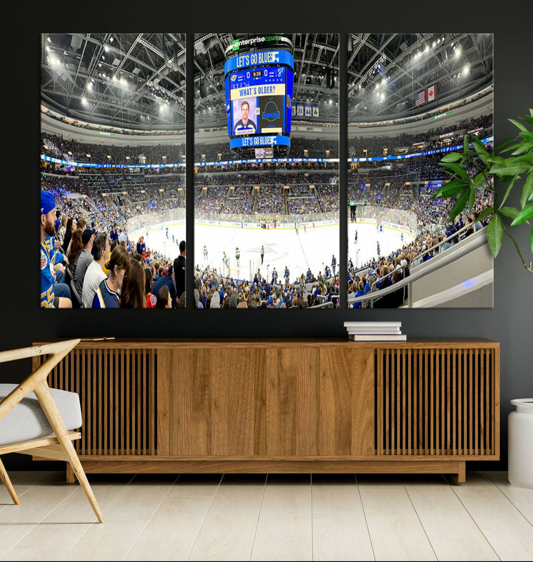 Wall art prints depicting the bustling scenes of the St. Louis Blues being cheered on by a full house at the Enterprise Center, beneath a large scoreboard.