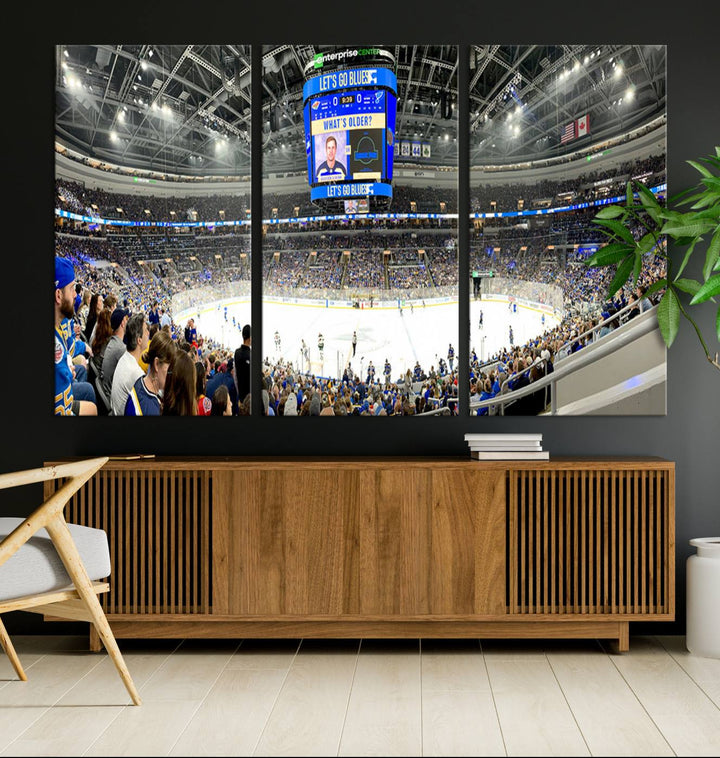 Wall art prints depicting the bustling scenes of the St. Louis Blues being cheered on by a full house at the Enterprise Center, beneath a large scoreboard.