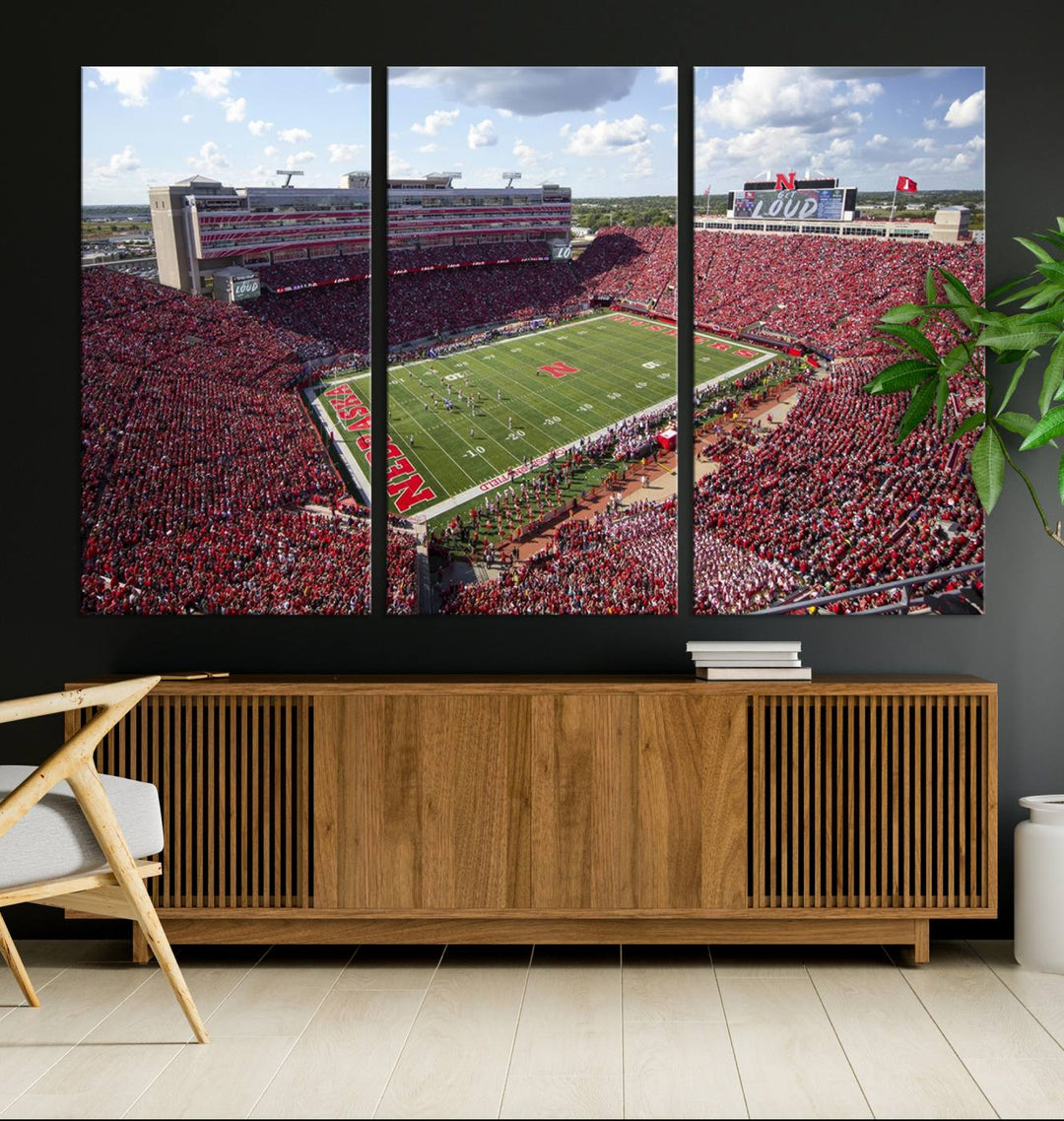 The University of Nebraska Cornhuskers Football Team Print showcases a vibrant triptych of Lincoln Memorial Stadium, depicting a packed football stadium filled with energetic fans. This handmade art piece is crafted in the USA and printed on premium canvas for a gallery-quality finish.