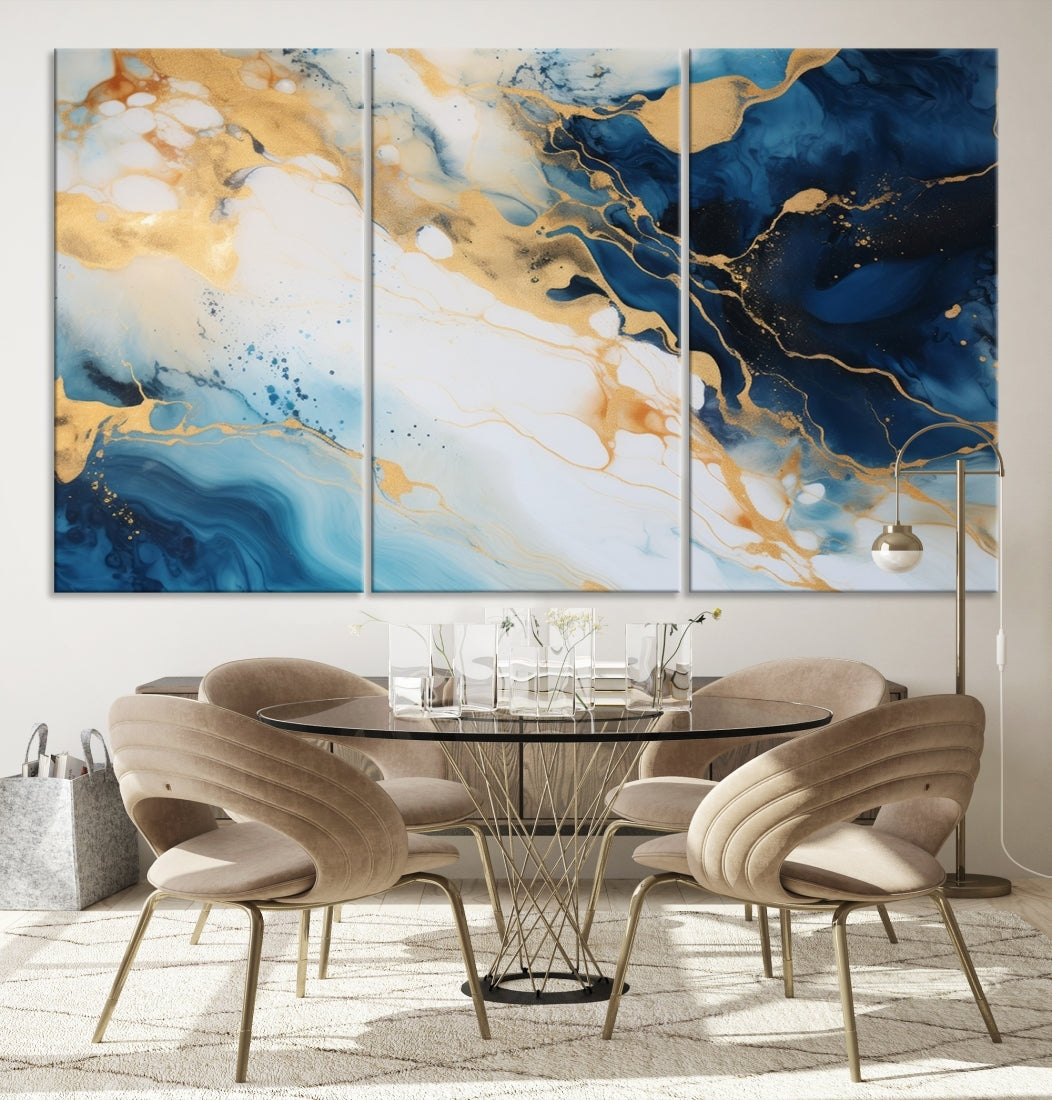 A modern living room featuring museum-quality Blue Gold Abstract Wall Art Print Contemporary art in a triptych arrangement.