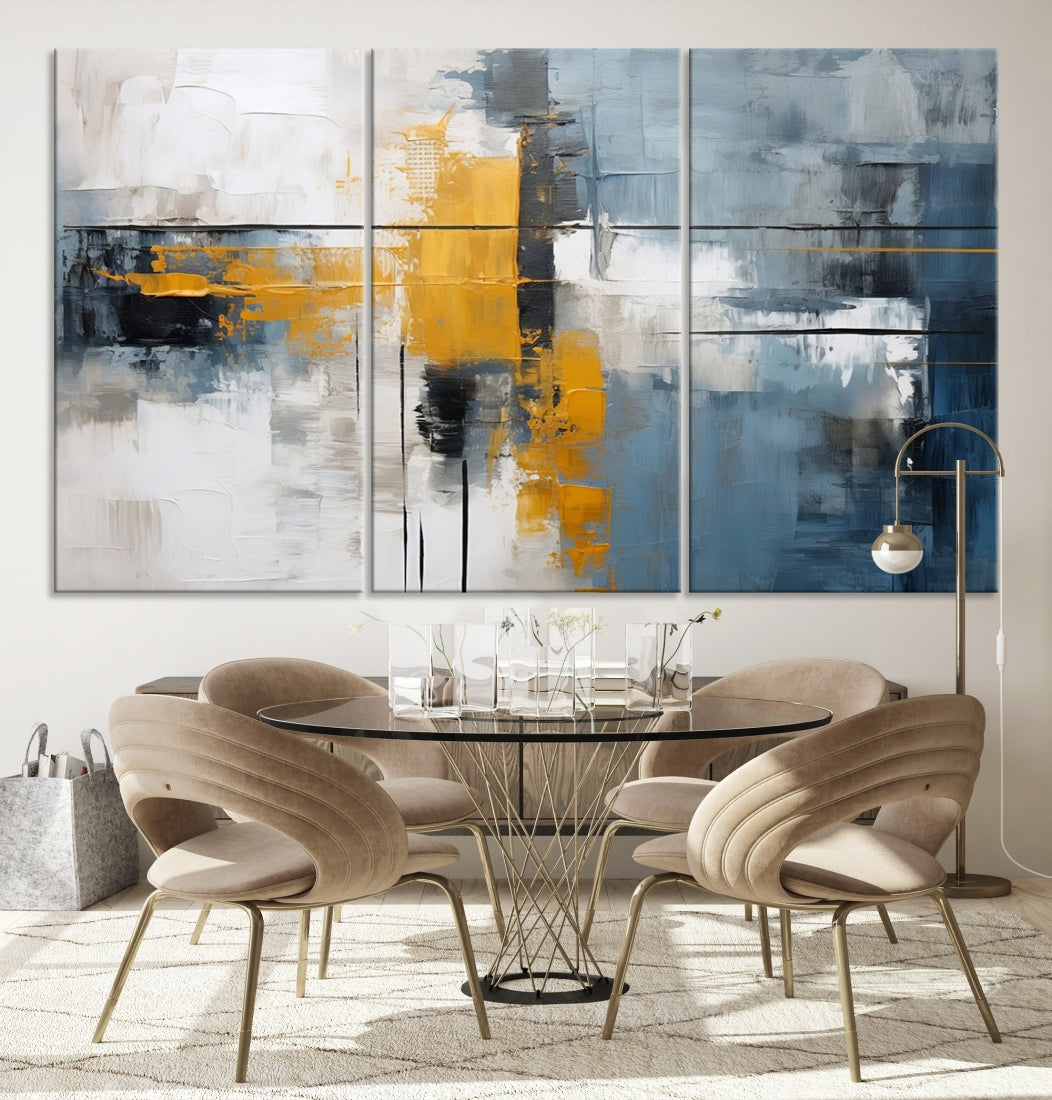 The Orange Abstract Wall Art Print features a series of white, blue, black, and yellow blocks arranged in a triptych format on museum-quality canvases. Proudly made in the USA and offered with free shipping.