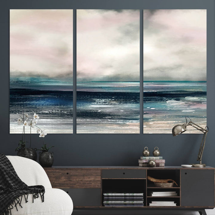 A contemporary abstract wall art canvas print in pastel pink, teal, and gray tones hangs on the wall.