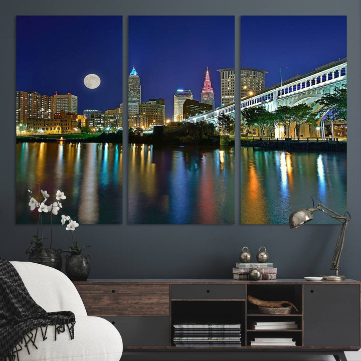 Cleveland City Lights Night Skyline Wall Art canvas showcases a moonlit cityscape reflected on water.