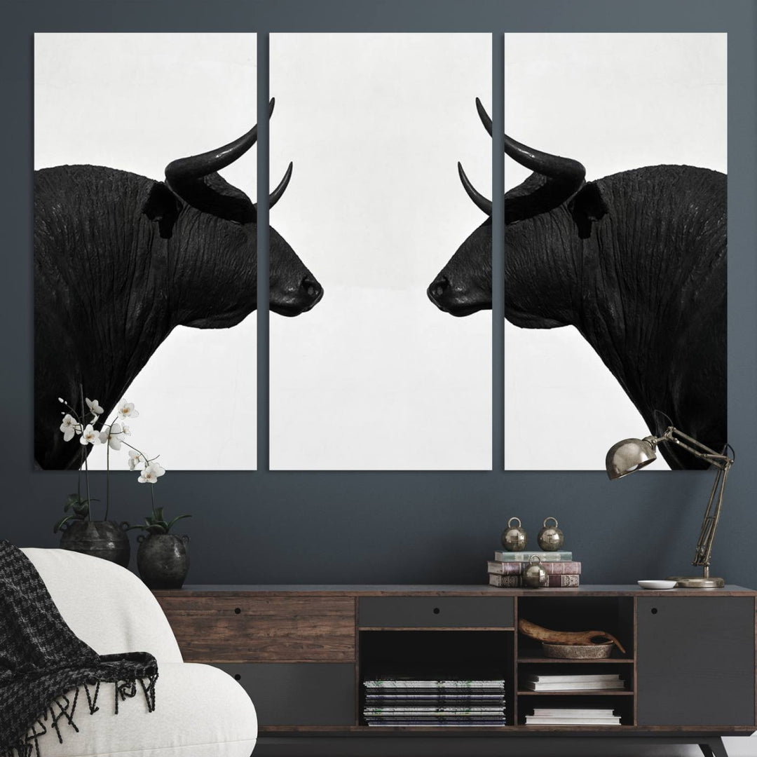 A framed canvas print featuring two black bull silhouettes, perfect for modern rustic decor.