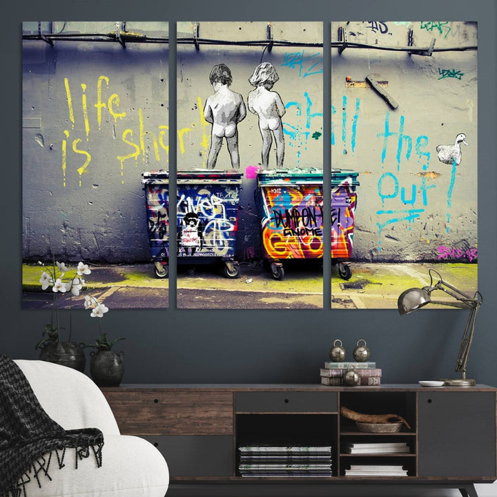 Banksys Life is Short graffiti, featuring kids and text, decorates the wall as a striking piece of framed canvas art.