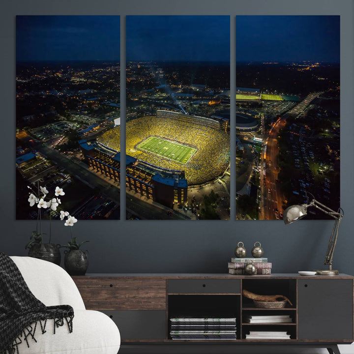 Aerial view of Michigan Stadium at night, surrounded by city lights, depicted on a Michigan Wolverines wall art canvas print.