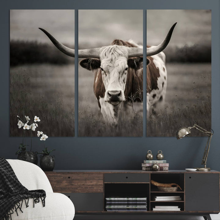 The Texas Longhorn Cow Canvas Wall Art Print adds a rustic touch to a living room.