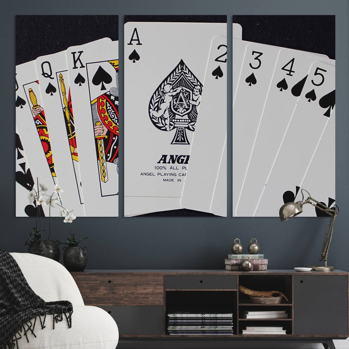 The Poker Wall Art - Playing Cards Canvas Wall Art Print features an Ace of Spades and Royal Flush design. This piece adds a classic charm to any space with its subtle emphasis on the Ace of Spades, making it perfect for game room decor.