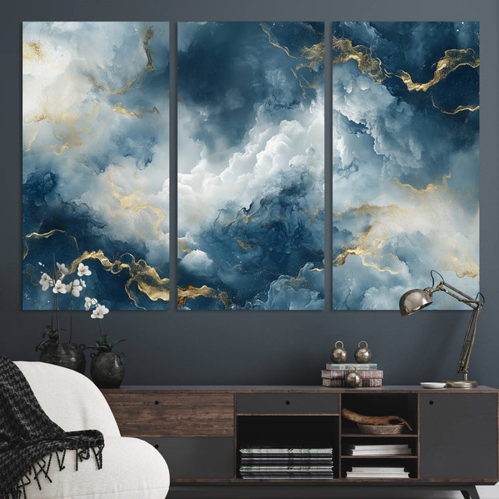 Modern living room featuring the Large Abstract Print - Luxe Blue and Gold Abstract Canvas Wall Art that showcases a bold cloudscape, perfect for modern home decor.