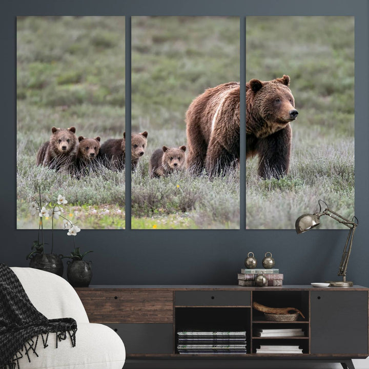 The large canvas print titled "Queen of the Tetons, 399 Grizzly Bear Cubs" showcases majestic wildlife photography of a bear and her cubs walking through the grass. This stunning canvas wall art, handmade in the USA, adds a charming touch to any room with its rustic decor appeal.