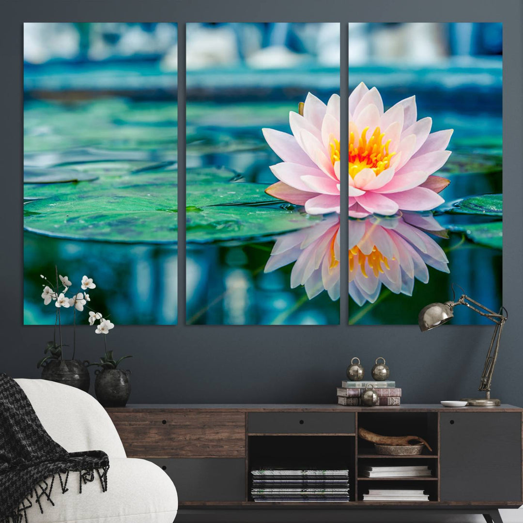 The Lotus Flower Canvas Print showcases a pink water lily with a yellow center gracefully floating on a calm pond.